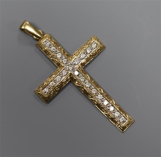 A modern engraved 9ct gold and cubic zirconia? set cross pendant, 66mm.